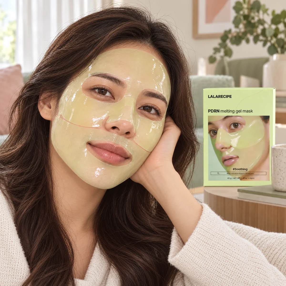 Long-haired woman wearing a PDRN hydrogel mask beside its pale green product box